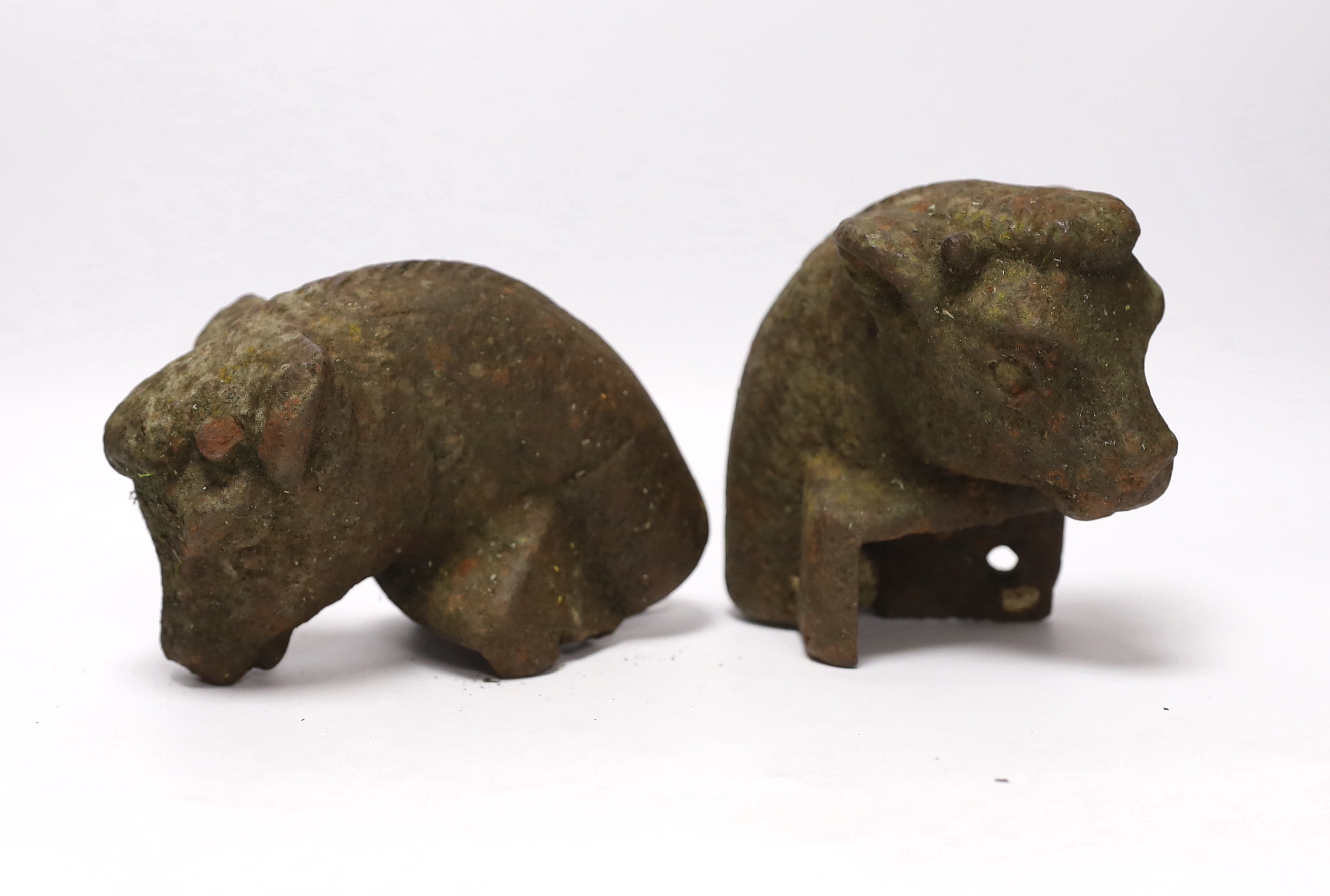 A pair of cast iron bull's head post finials, 13cm